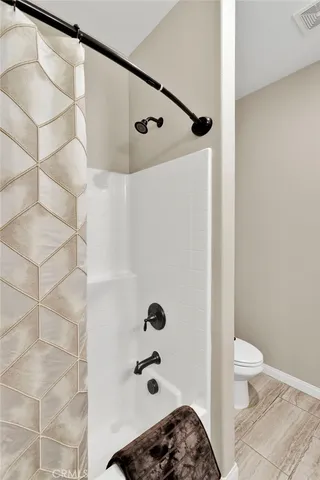 a living room with furniture a dining table and a potted plant