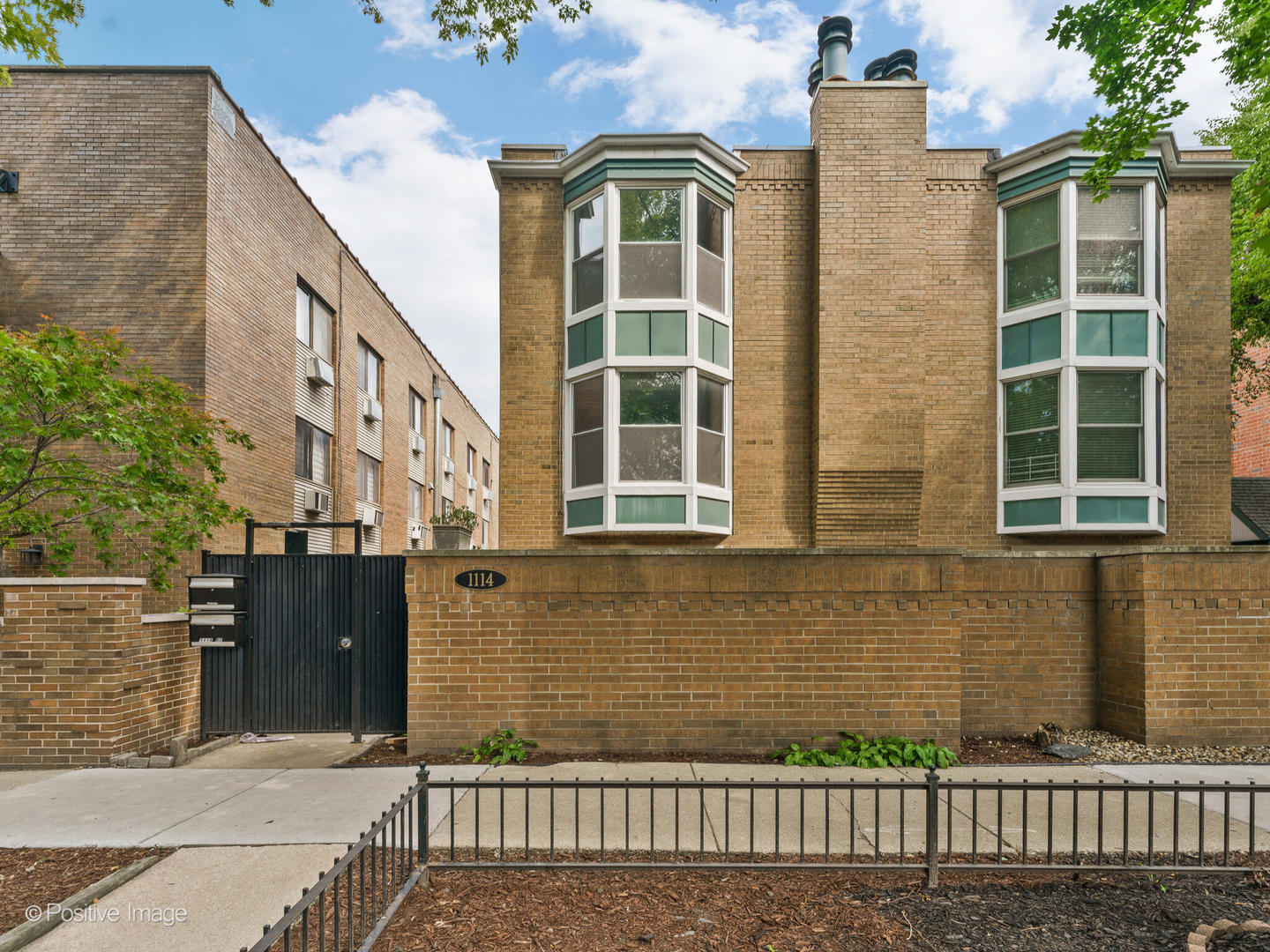1114 West Altgeld Street, Unit A2 Chicago, IL 60614 - Photo 1 of 19 a front view of a house with a yard