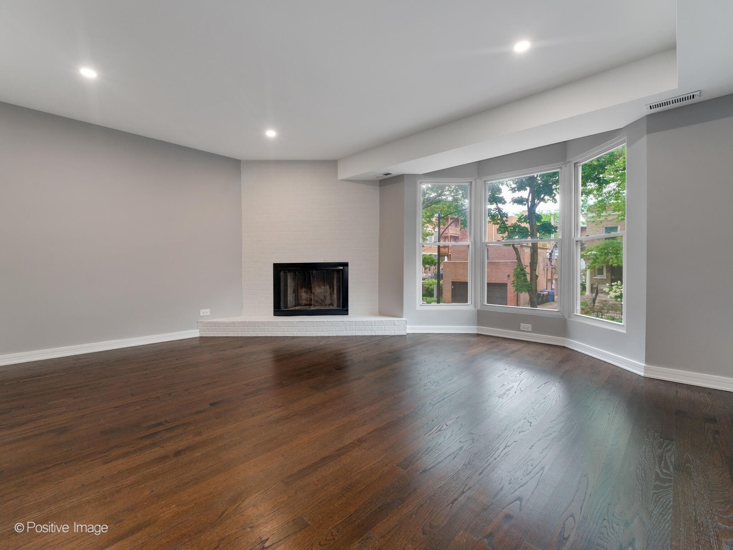 1114 West Altgeld Street, Unit A2 Chicago, IL 60614 - Photo 13 of 19 a view of a room with wooden floor and a fireplace