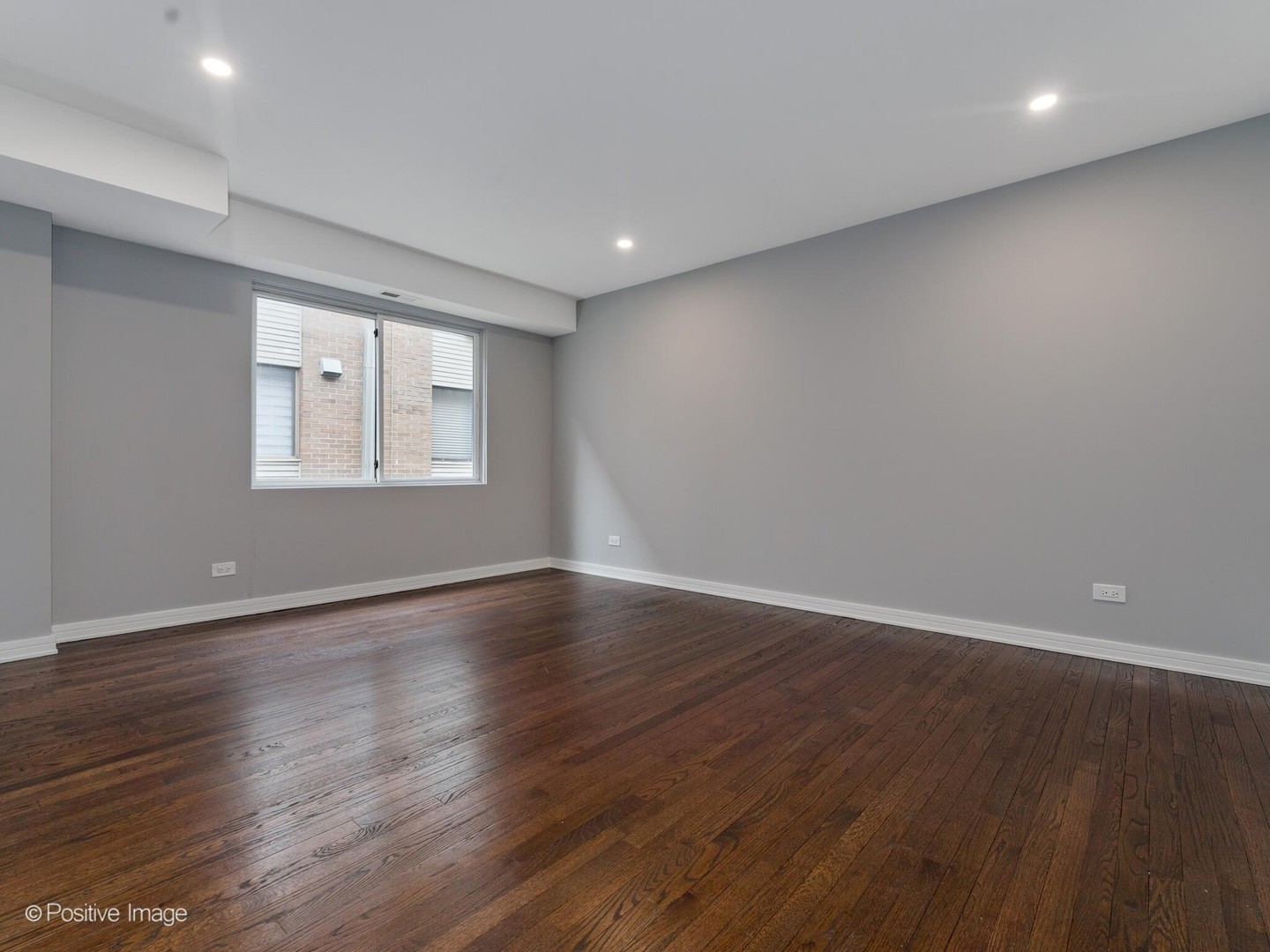 1114 West Altgeld Street, Unit A2 Chicago, IL 60614 - Photo 15 of 19 a view of an empty room with wooden floor and a window
