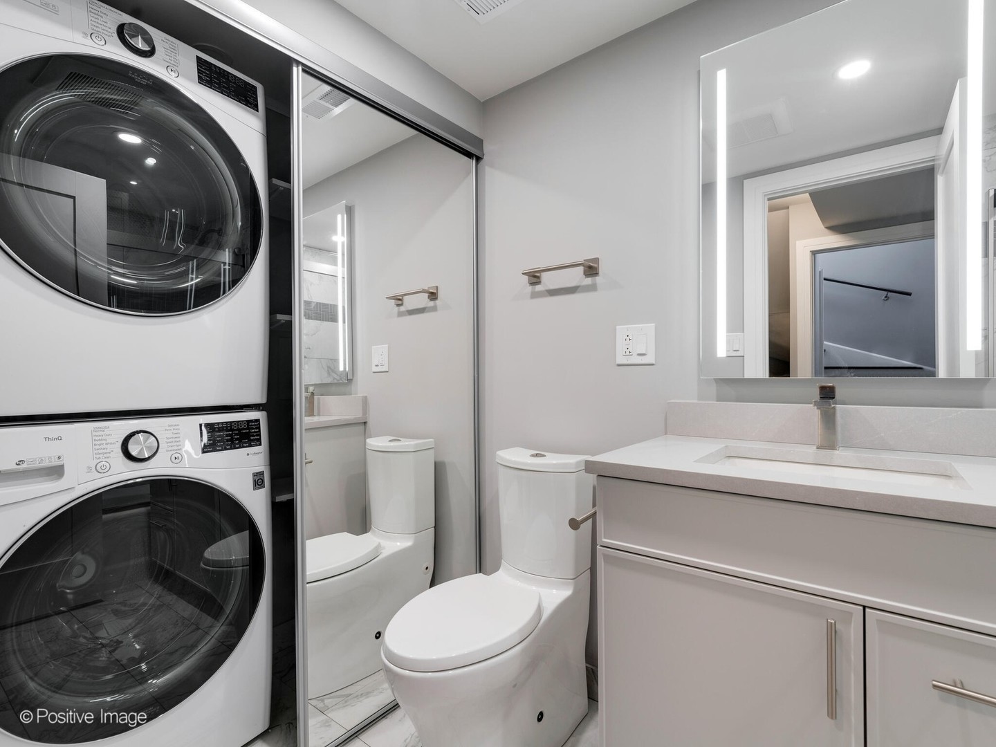 1114 West Altgeld Street, Unit A2 Chicago, IL 60614 - Photo 17 of 19 a bathroom with a sink a washer and dryer
