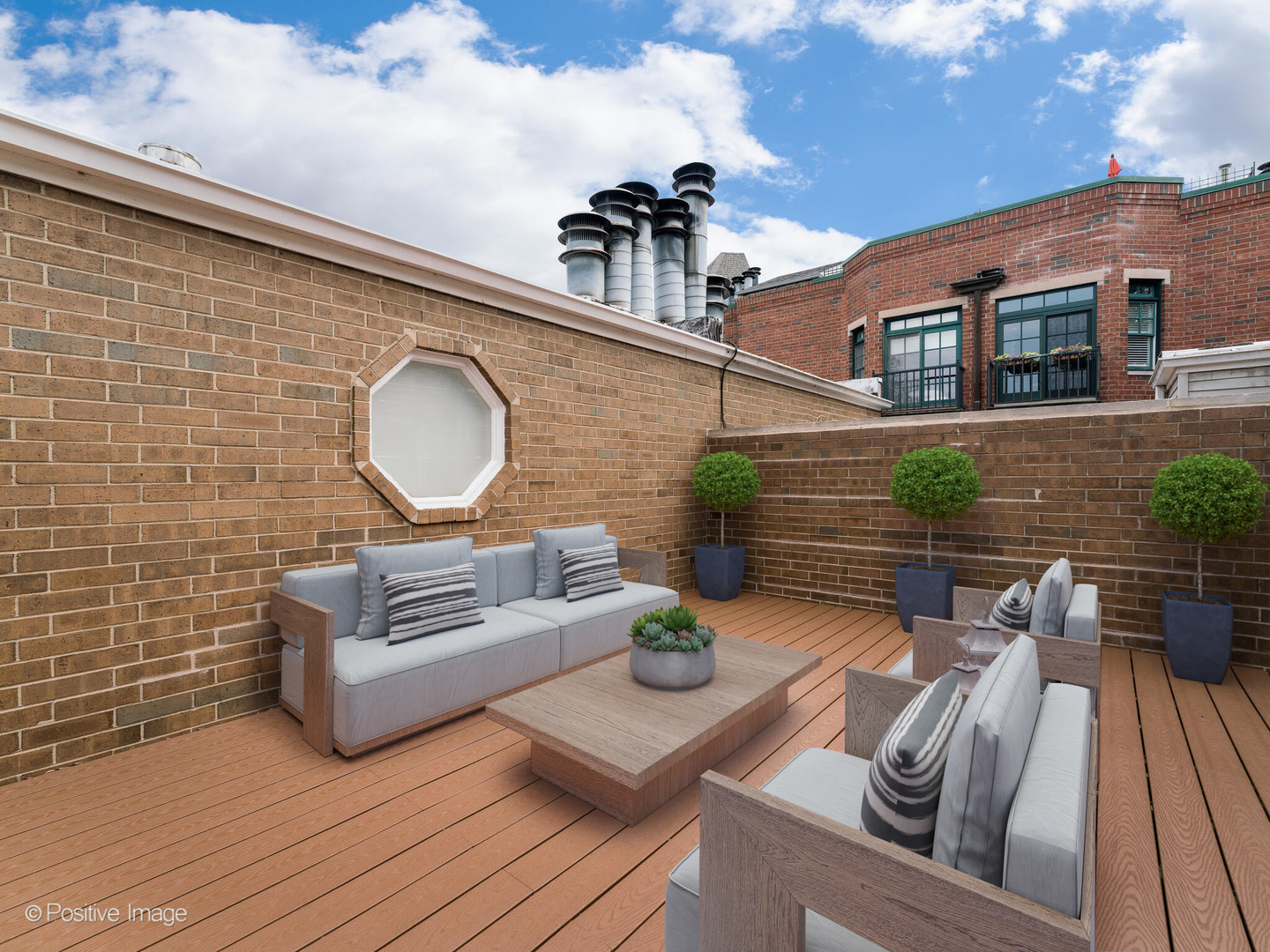 1114 West Altgeld Street, Unit A2 Chicago, IL 60614 - Photo 18 of 19 a view of a deck with couches table and chairs with wooden floor