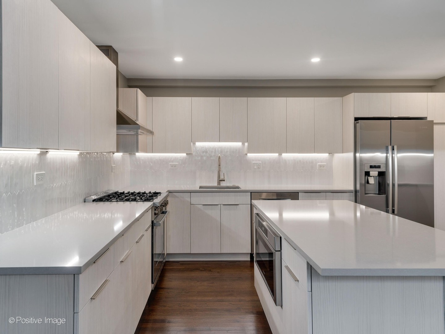 1114 West Altgeld Street, Unit A2 Chicago, IL 60614 - Photo 7 of 19 a kitchen with stainless steel appliances granite countertop a sink a stove and a refrigerator