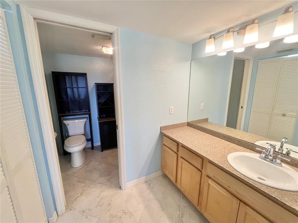 175 Kings Highway, Unit 236 Punta Gorda, FL 33983 - Photo 13 of 26 a bathroom with a granite countertop sink toilet and shower