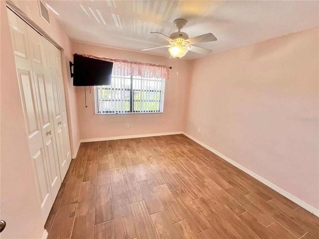 175 Kings Highway, Unit 236 Punta Gorda, FL 33983 - Photo 16 of 26 an empty room with wooden floor and windows