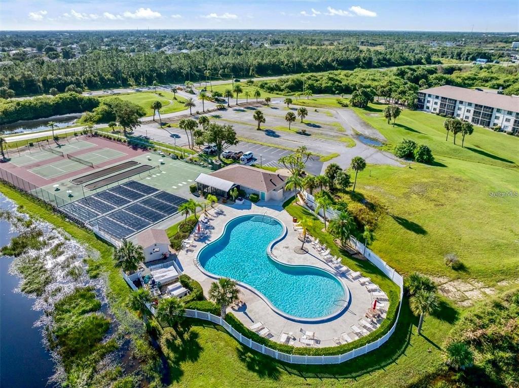 175 Kings Highway, Unit 236 Punta Gorda, FL 33983 - Photo 22 of 26 a view of a swimming pool with a patio and a garden
