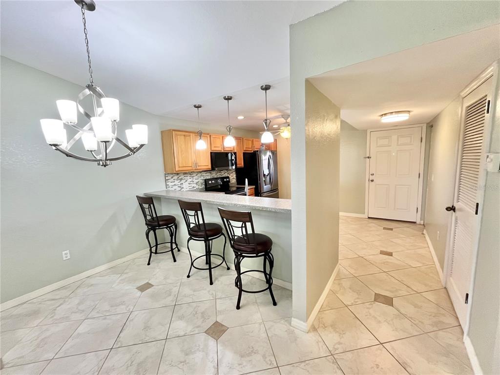 175 Kings Highway, Unit 236 Punta Gorda, FL 33983 - Photo 7 of 26 a view of a dining room with furniture and chandelier