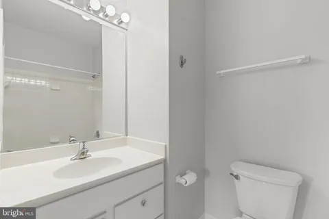 a spacious bathroom with a shower a sink and a mirror