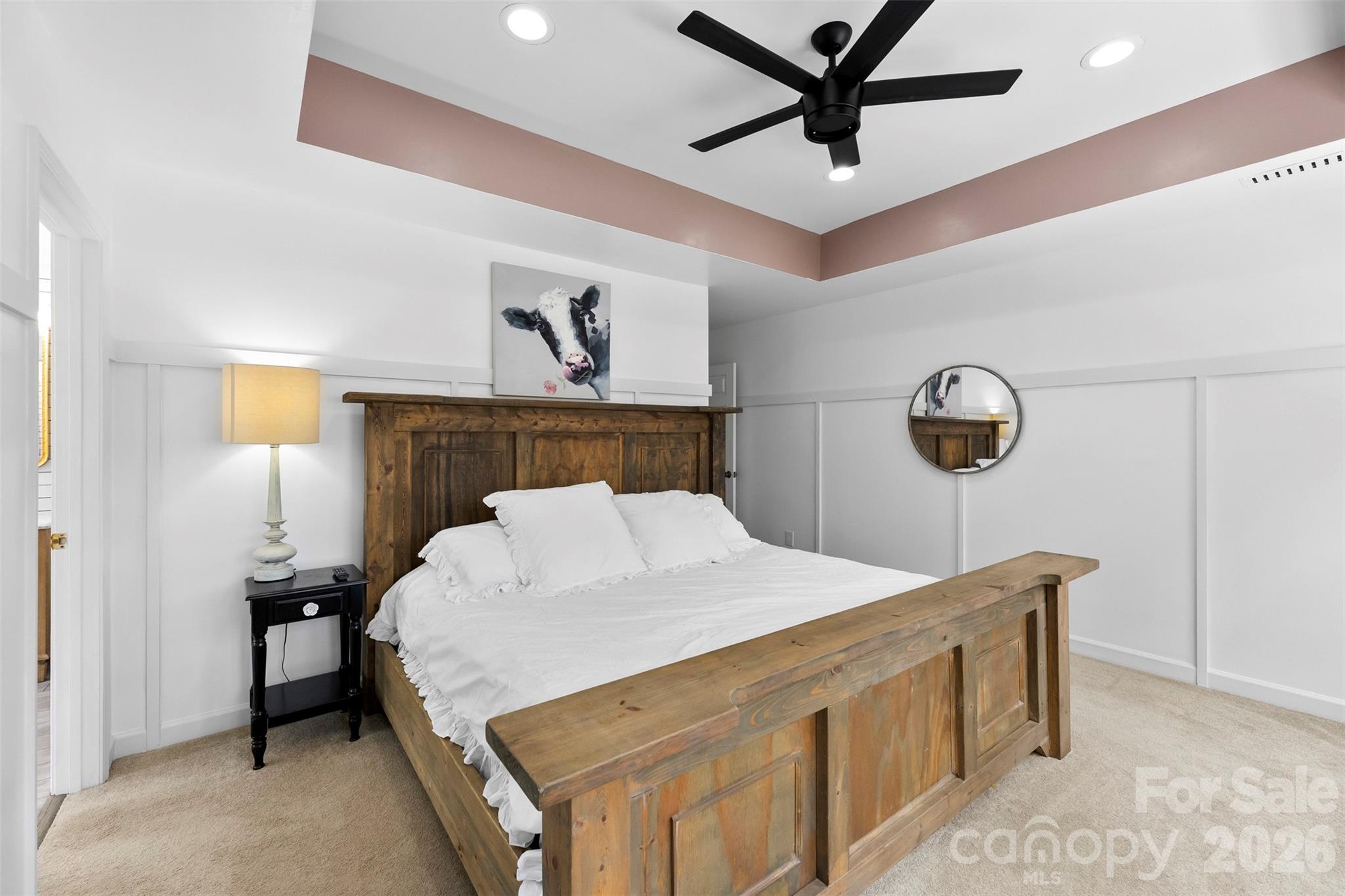 7901 McConnell Road Denver, NC 28037 - Photo 11 of 27 a bedroom with a bed and a chandelier