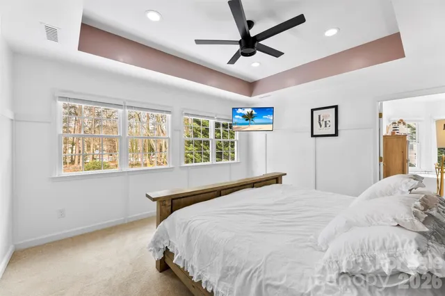 a bedroom with a large bed and a large window