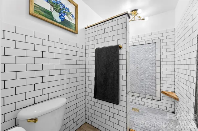 a bathroom with a shower and toilet