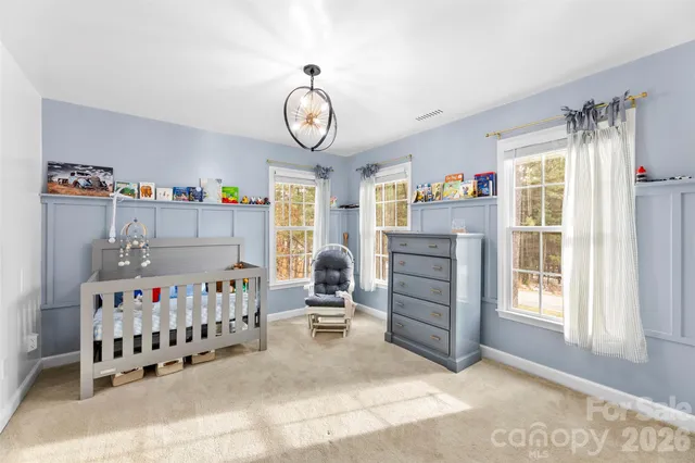 a bed room with a bed and a baby crib