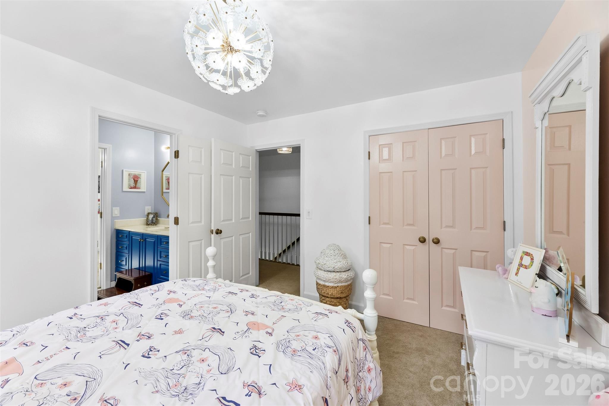 7901 McConnell Road Denver, NC 28037 - Photo 19 of 27 a spacious bedroom with a bed and a chandelier