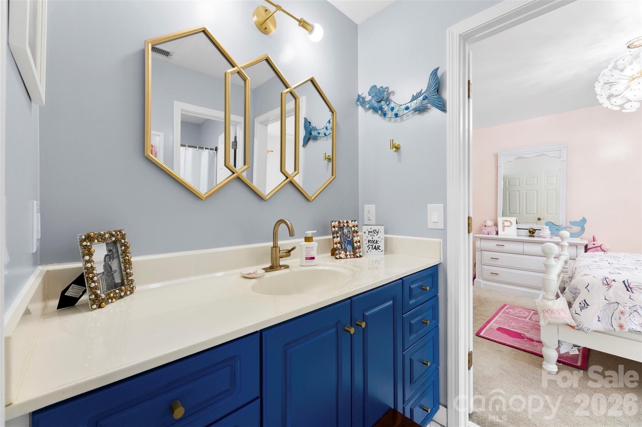 7901 McConnell Road Denver, NC 28037 - Photo 22 of 27 a bathroom with a sink and a mirror