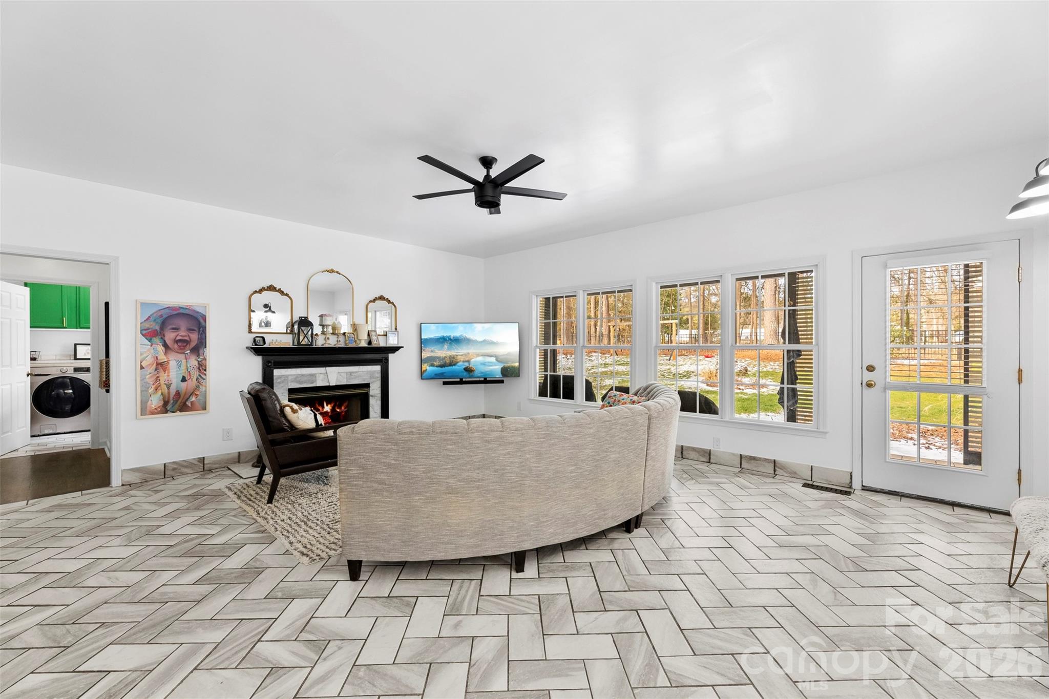 7901 McConnell Road Denver, NC 28037 - Photo 7 of 27 a living room with furniture a dining table and a fireplace