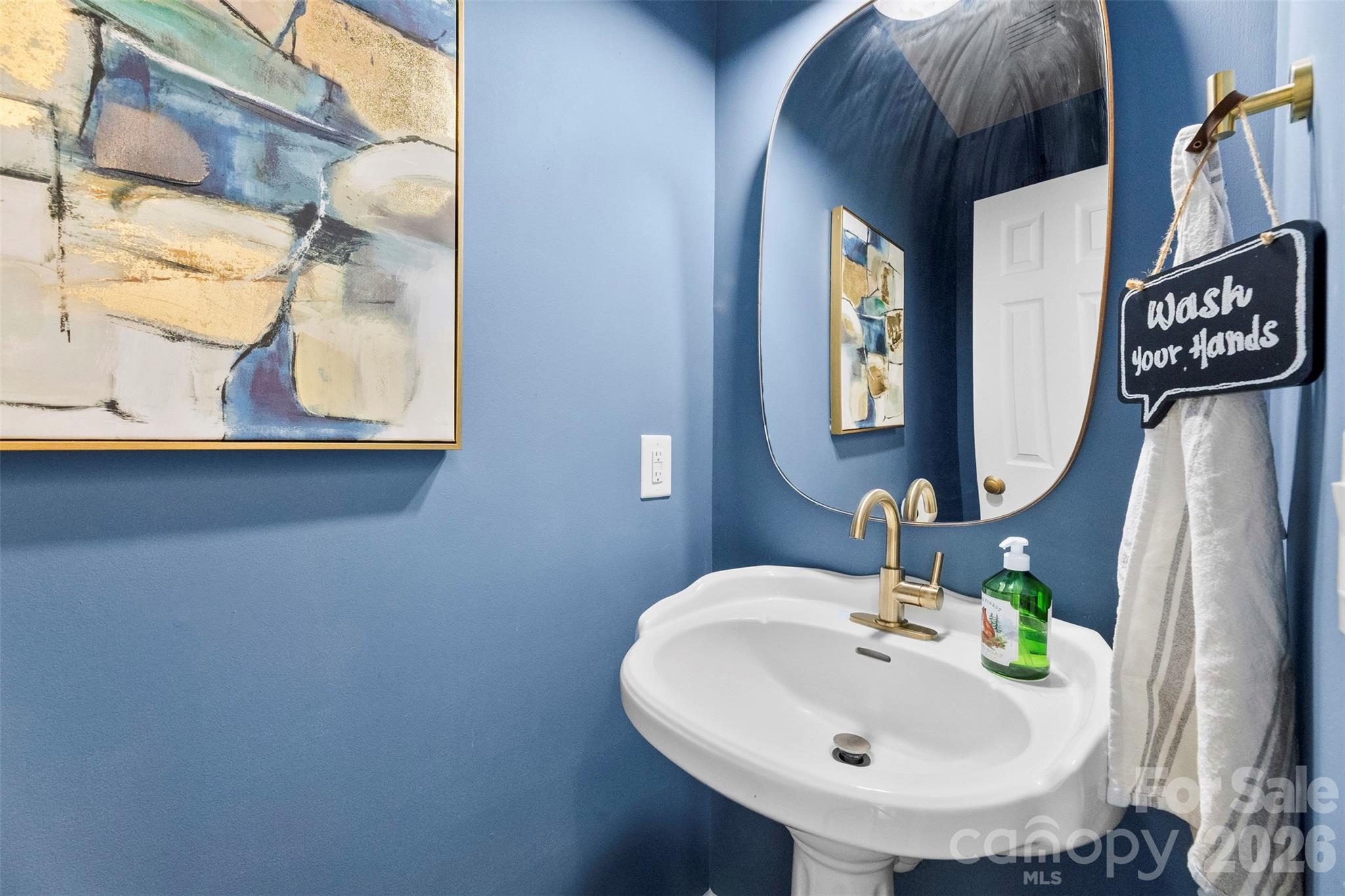 7901 McConnell Road Denver, NC 28037 - Photo 9 of 27 a bathroom with a sink and mirror