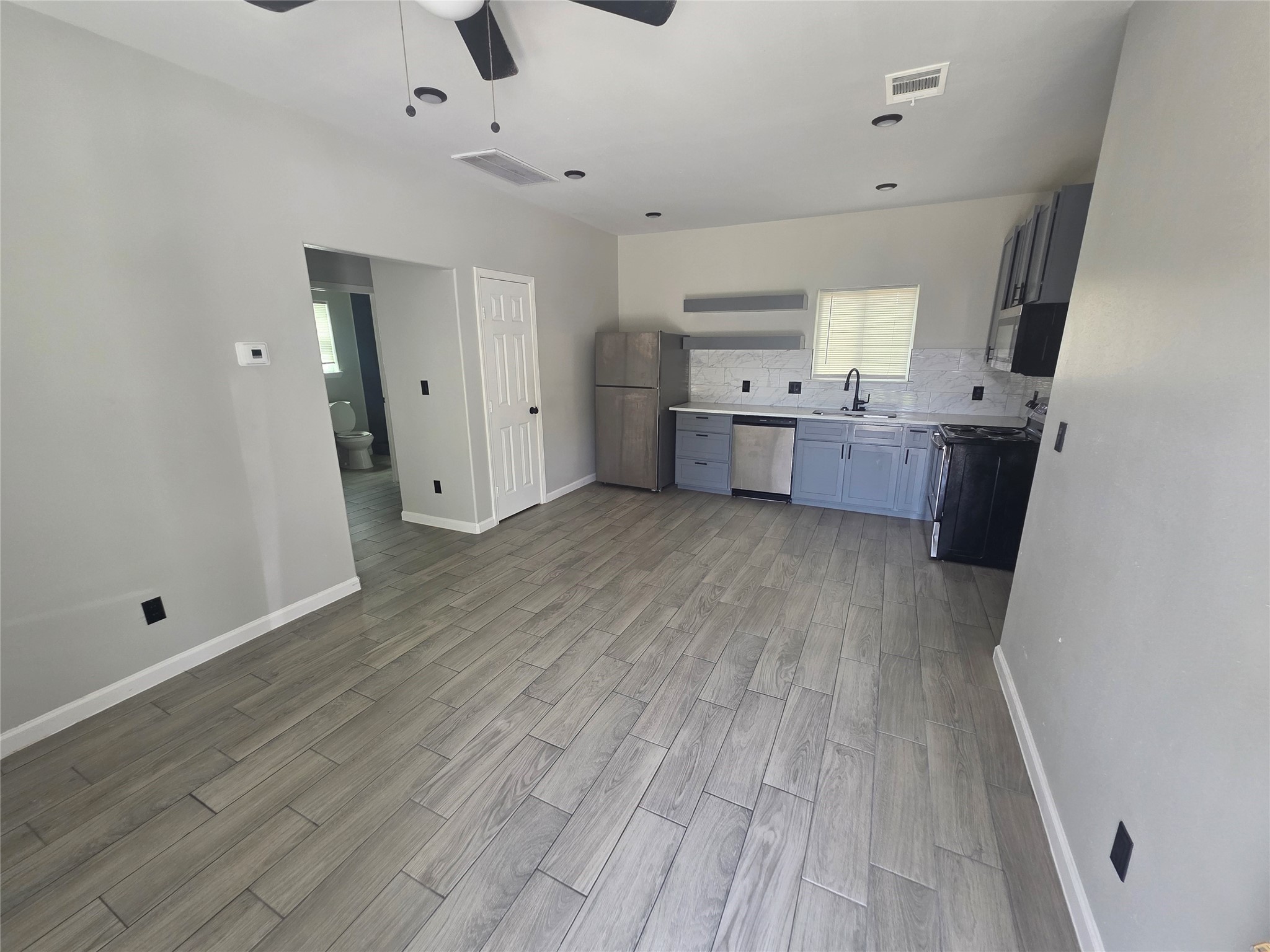 3221 Ennis Street, Unit A Houston, TX 77004 - Photo 4 of 8 a view of a kitchen with wooden floor