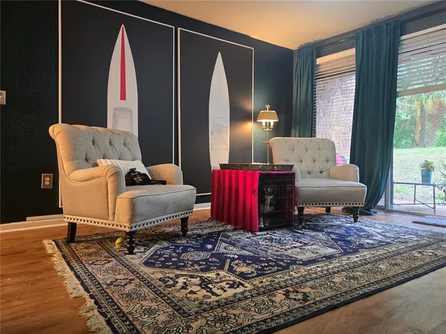 a living room with furniture rug and window