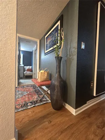 a bedroom with a bed and painting on the wall