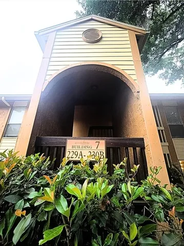 a dining room with wooden floor a chandelier a wooden table and chairs