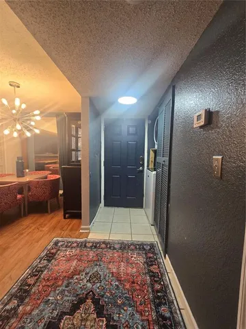 a kitchen with granite countertop a sink cabinets and stainless steel appliances
