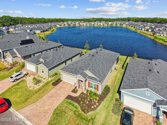 an aerial view of a house with a ocean view