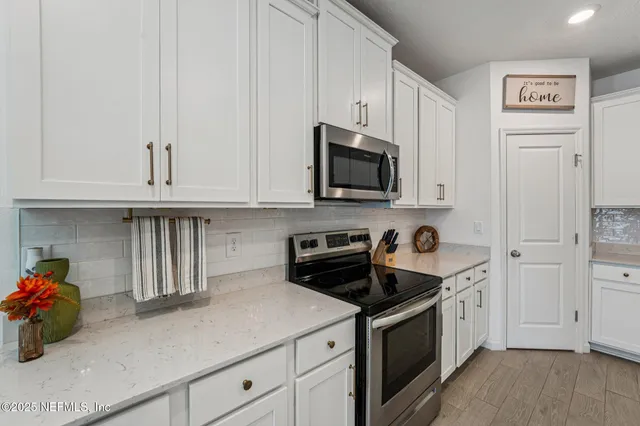 a spacious bedroom with a bed and a chandelier
