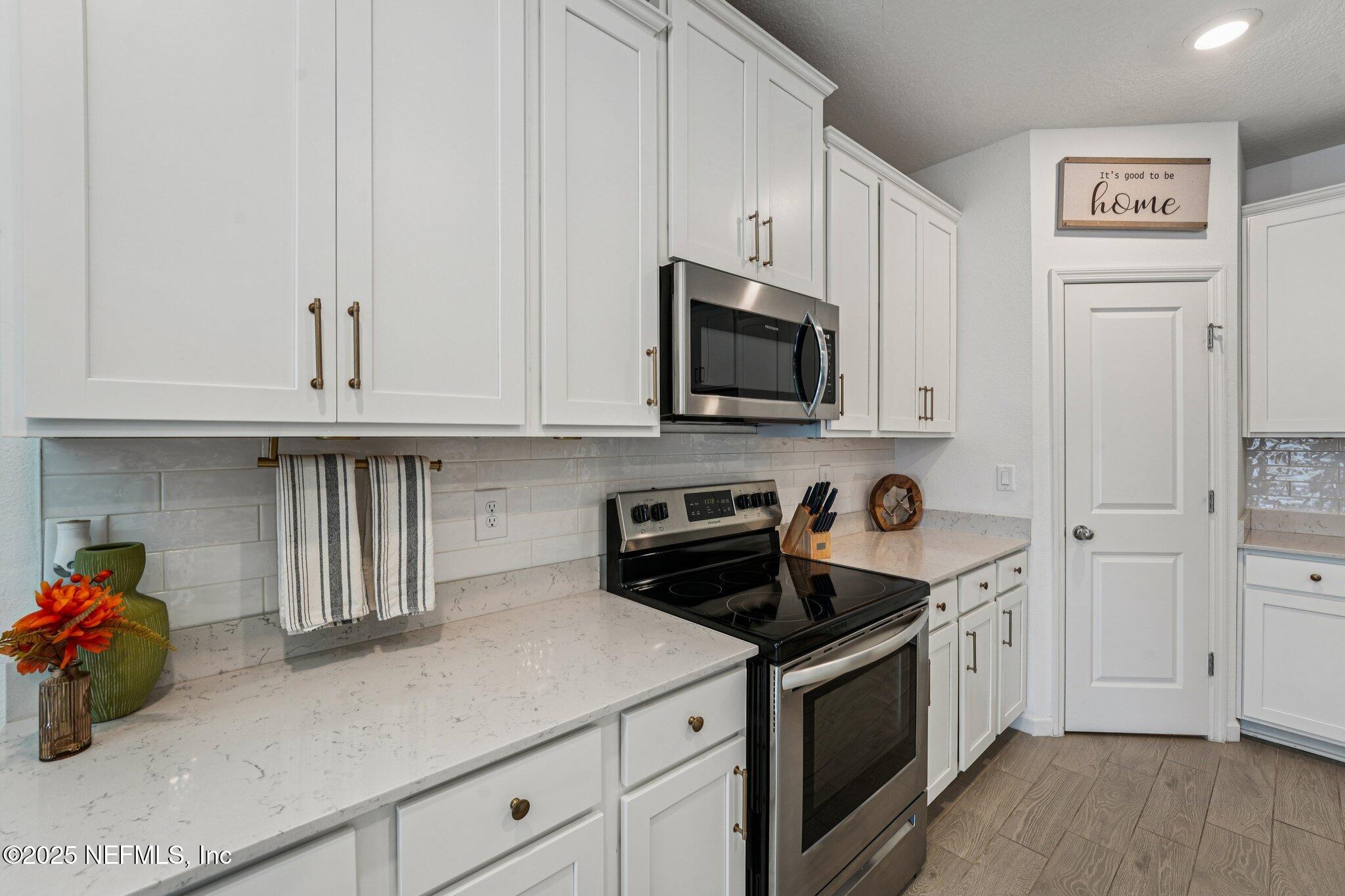 428 Lake Sinclair Street St. Augustine, FL 32084 - Photo 19 of 72 a kitchen with stainless steel appliances granite countertop a sink a stove and cabinets