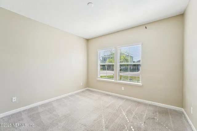 a bathroom with a double vanity sink a large mirror and a bathtub