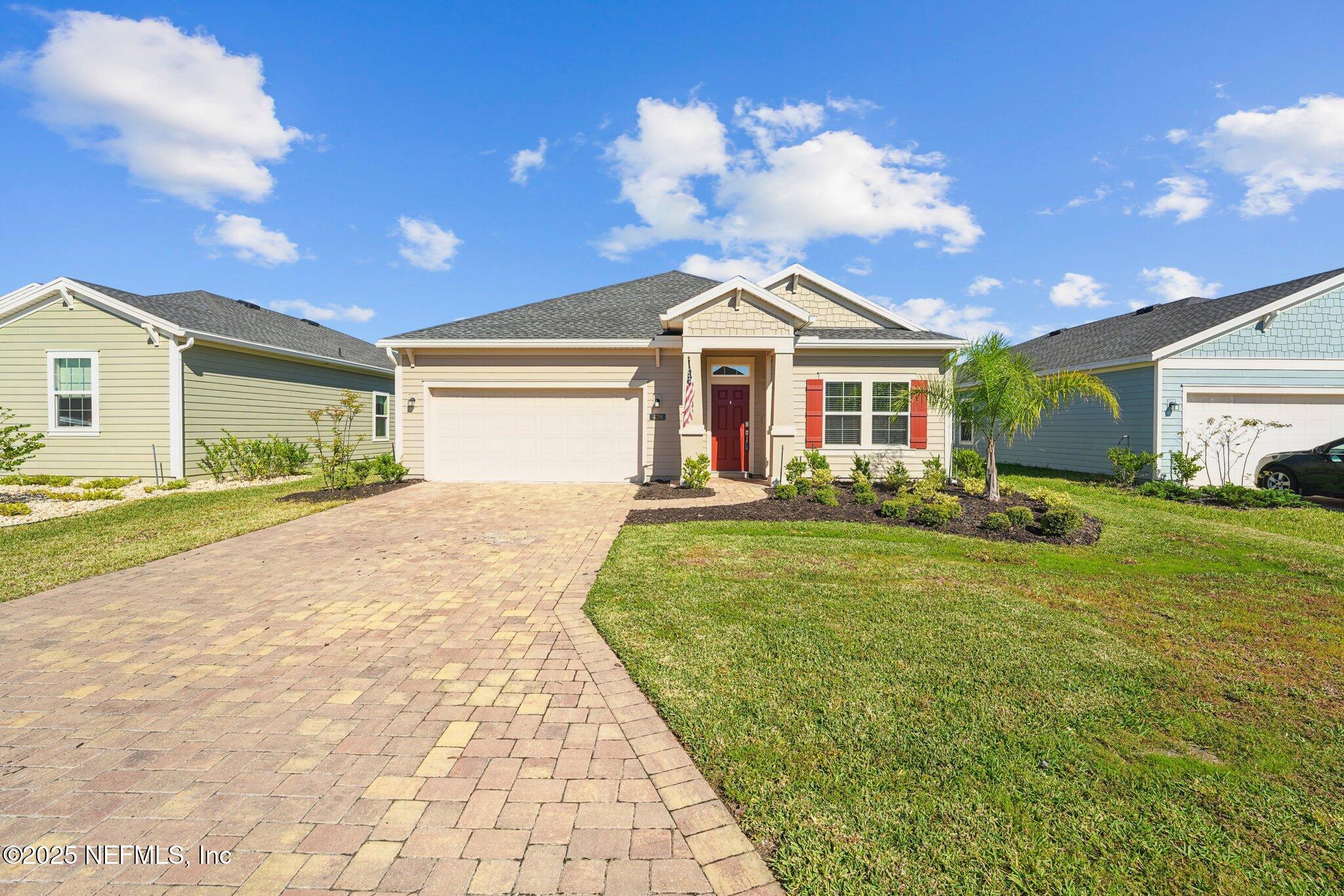 428 Lake Sinclair Street St. Augustine, FL 32084 - Photo 3 of 72 a front view of a house with garden