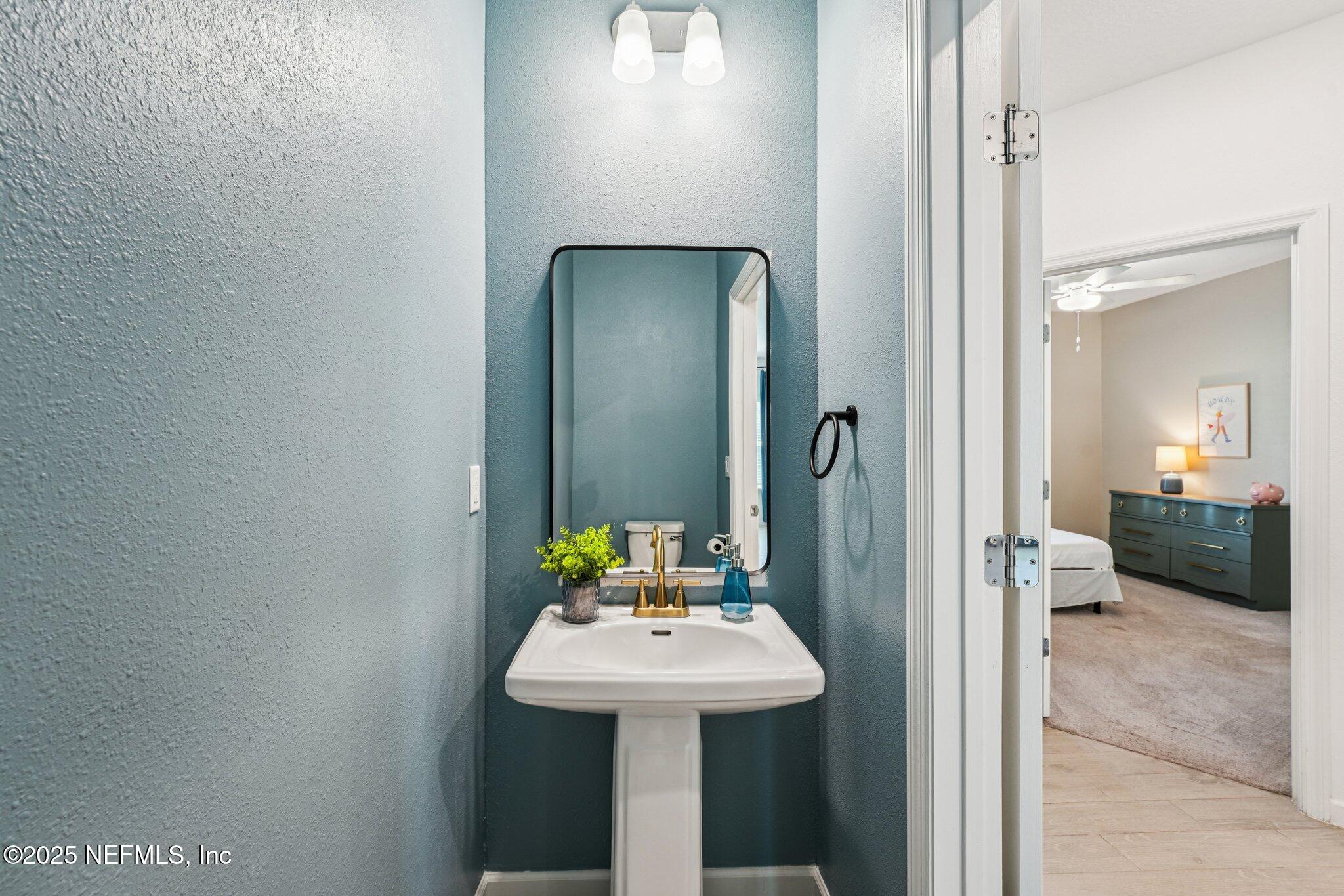 428 Lake Sinclair Street St. Augustine, FL 32084 - Photo 33 of 72 a bathroom with a sink and a mirror