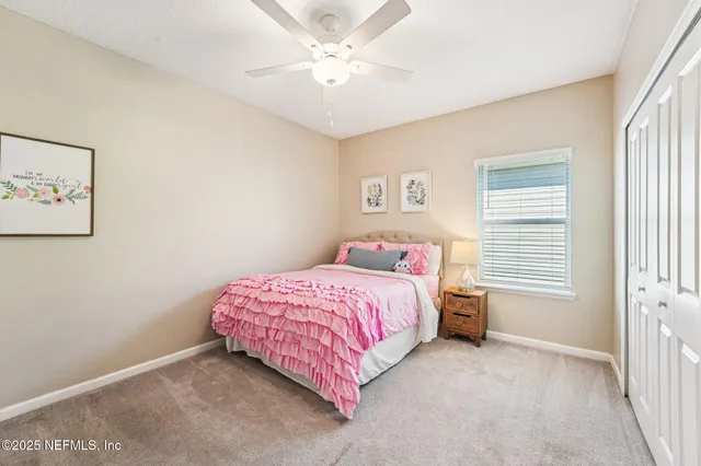 a view of a livingroom with a ceiling fan and window