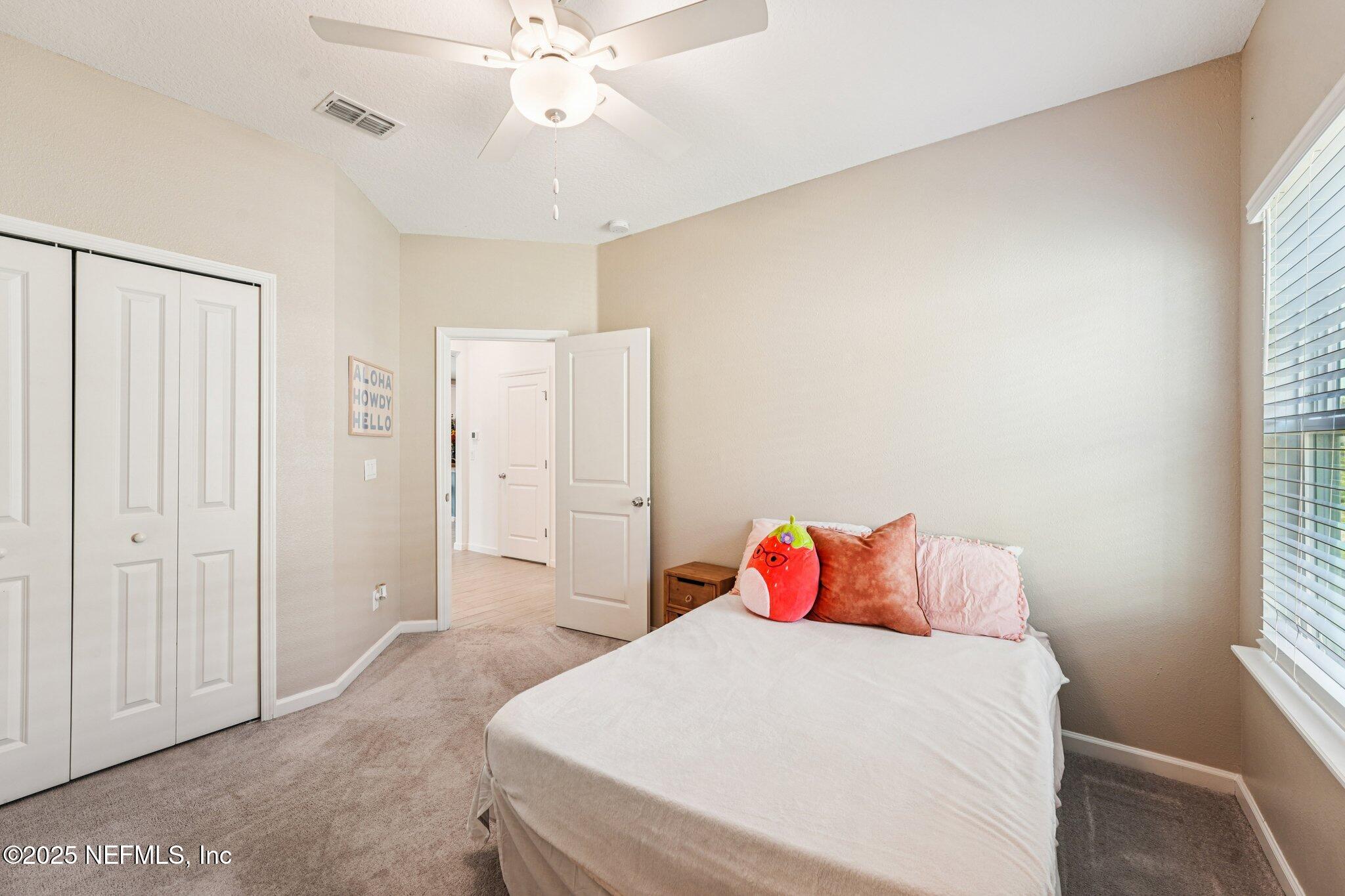 428 Lake Sinclair Street St. Augustine, FL 32084 - Photo 37 of 72 a bedroom with a bed and a chandelier