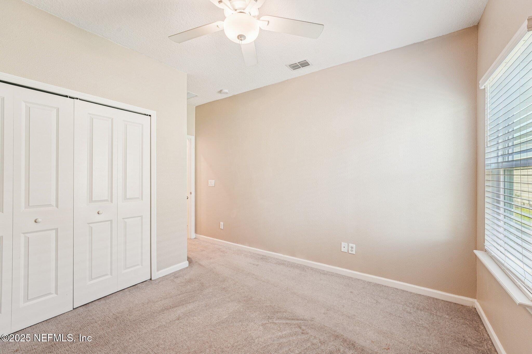 428 Lake Sinclair Street St. Augustine, FL 32084 - Photo 39 of 72 an empty room with windows and fan