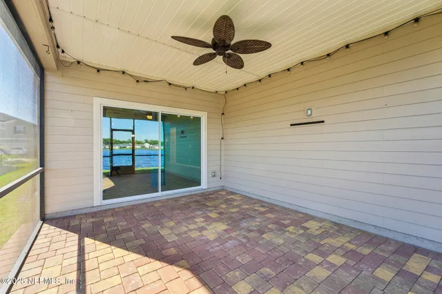 a view of a house with a big yard and potted plants