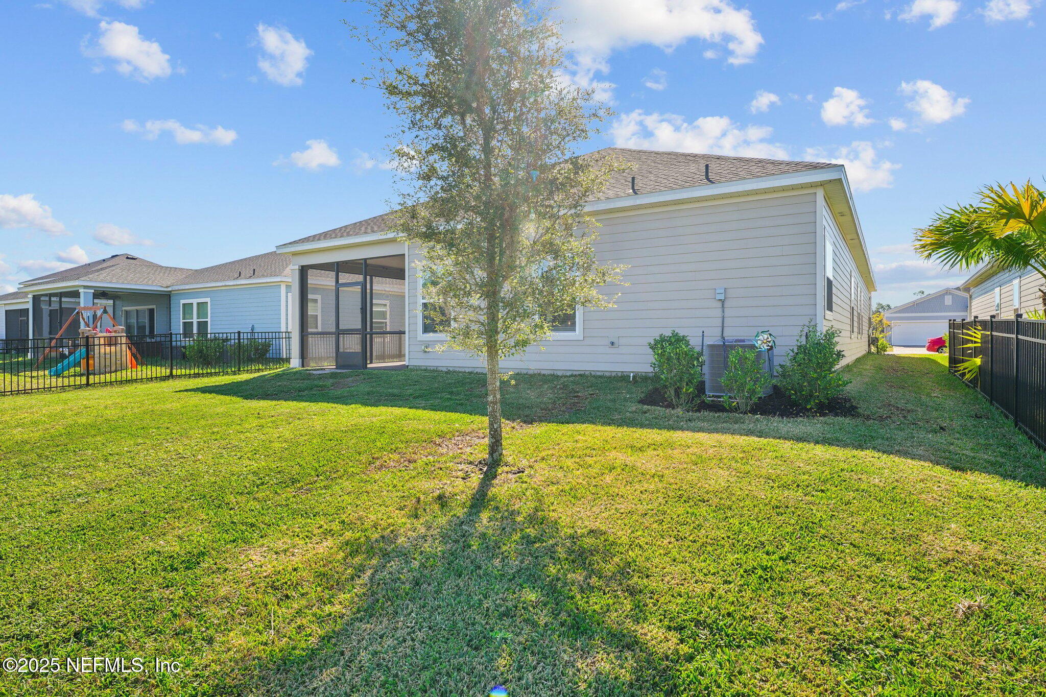 428 Lake Sinclair Street St. Augustine, FL 32084 - Photo 46 of 72 a view of a house with a yard and palm trees