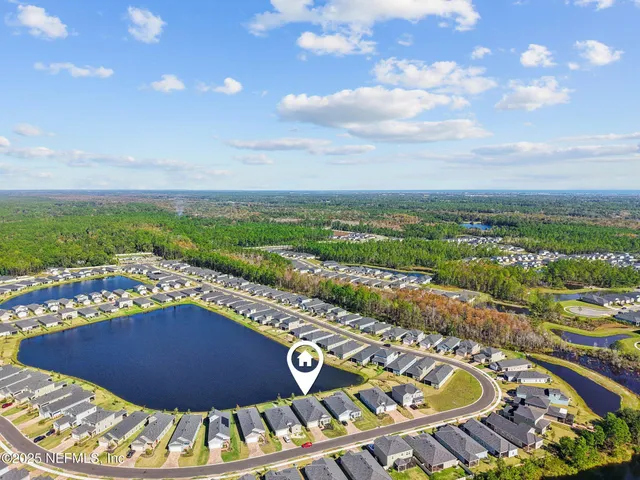 an aerial view of a house with a swimming pool
