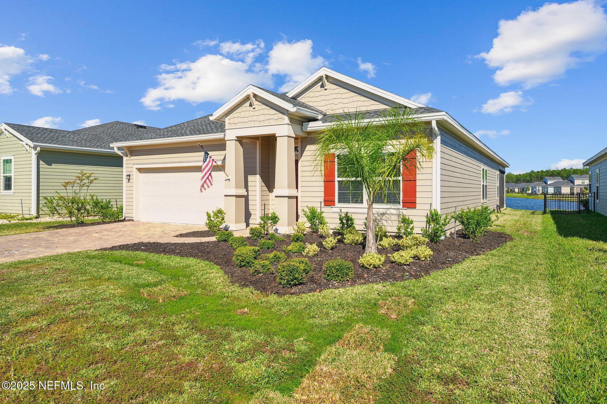 428 Lake Sinclair Street St. Augustine, FL 32084 - Photo 5 of 72 a front view of a house with a yard