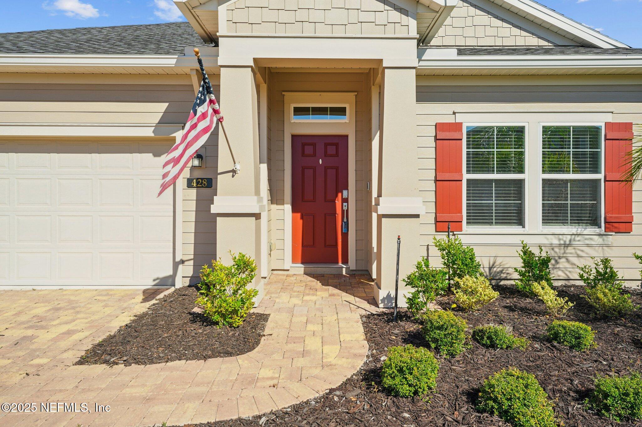 428 Lake Sinclair Street St. Augustine, FL 32084 - Photo 6 of 72 a front view of a house with a yard