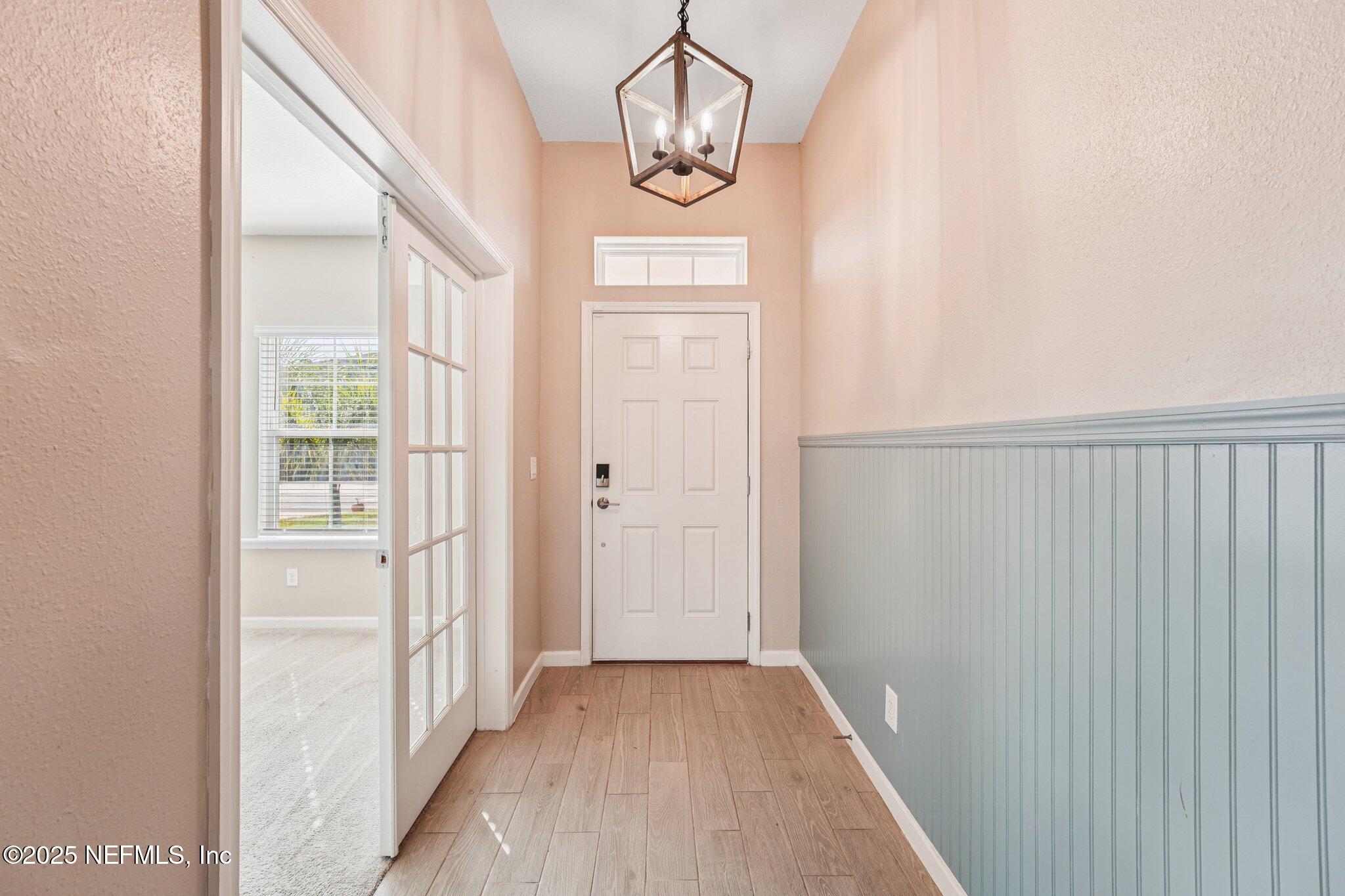 428 Lake Sinclair Street St. Augustine, FL 32084 - Photo 7 of 72 a view of a hallway with wooden floor and staircase