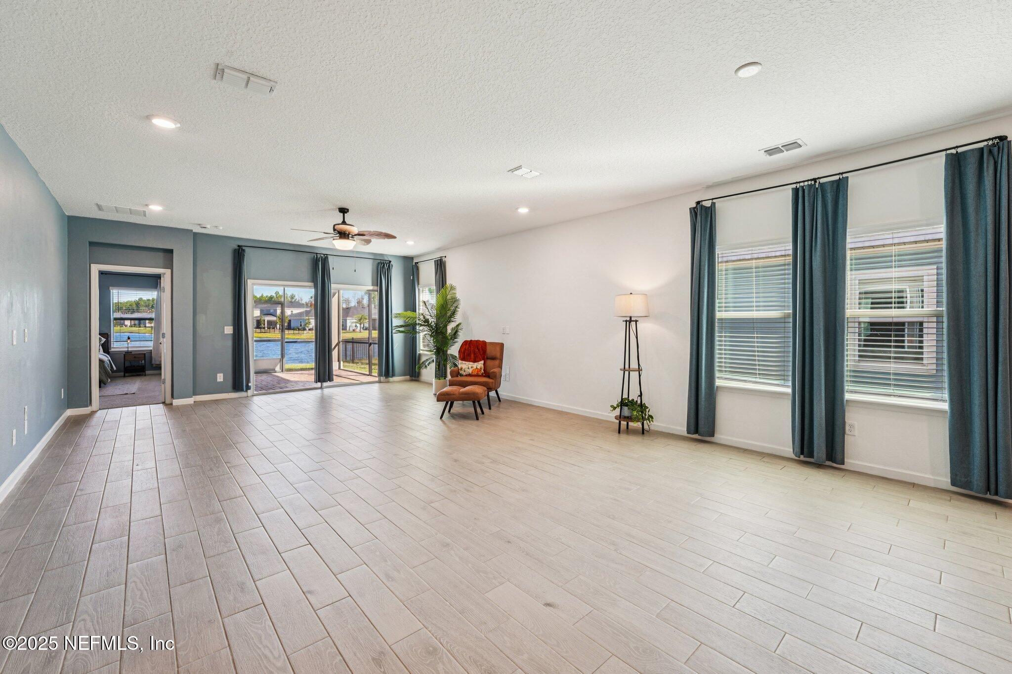 428 Lake Sinclair Street St. Augustine, FL 32084 - Photo 8 of 72 a view of an empty room with window and wooden floor