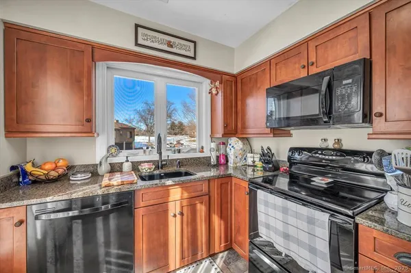 a kitchen with stainless steel appliances wooden cabinets and a stove top oven