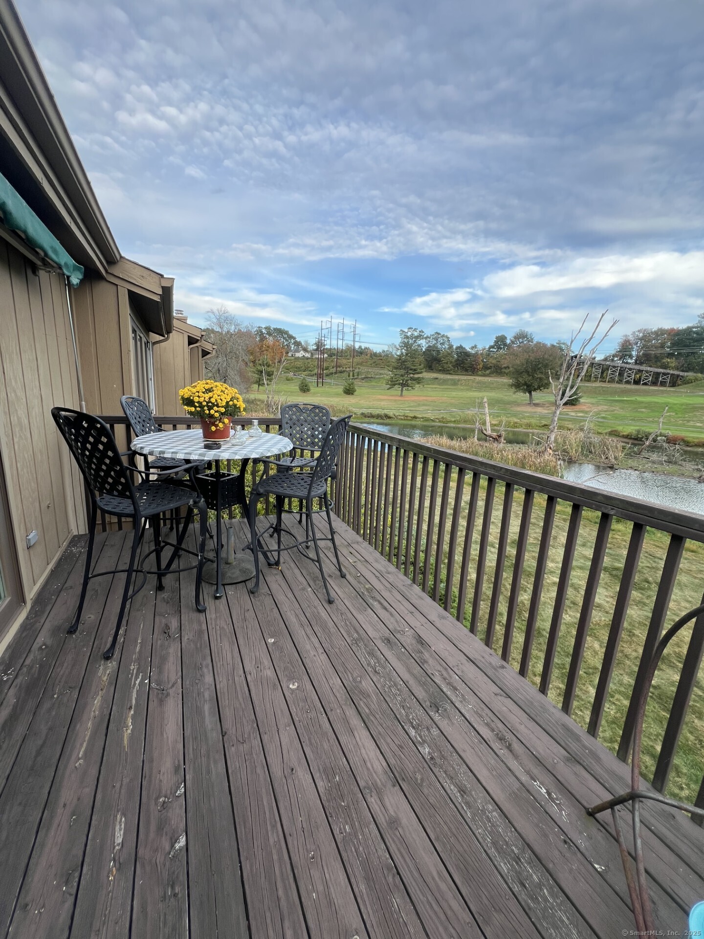 10 Pilgrims Harbor, Unit D Wallingford, CT 06492 - Photo 27 of 32 a balcony with wooden floor table and chairs