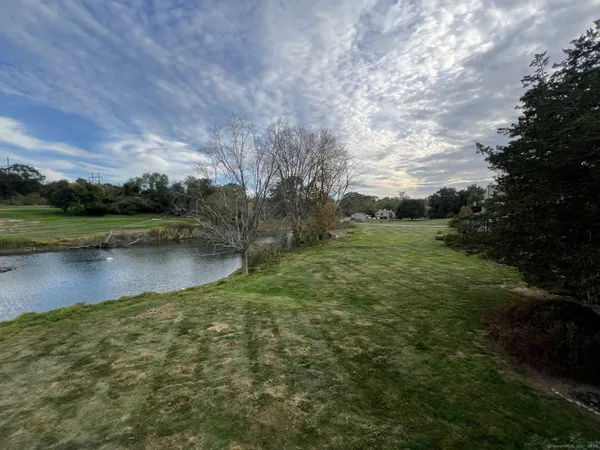 a view of a lake with houses in the back
