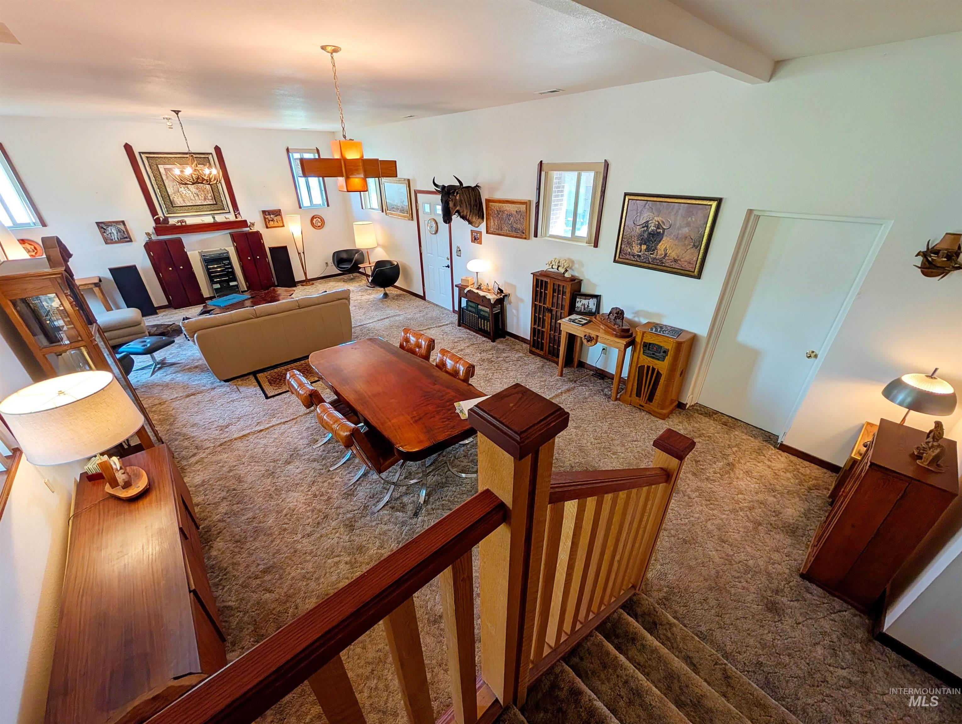 11100 Bens Road Cascade, ID 83611 - Photo 13 of 35 Open-concept living area with a vaulted ceiling and an exposed beam
