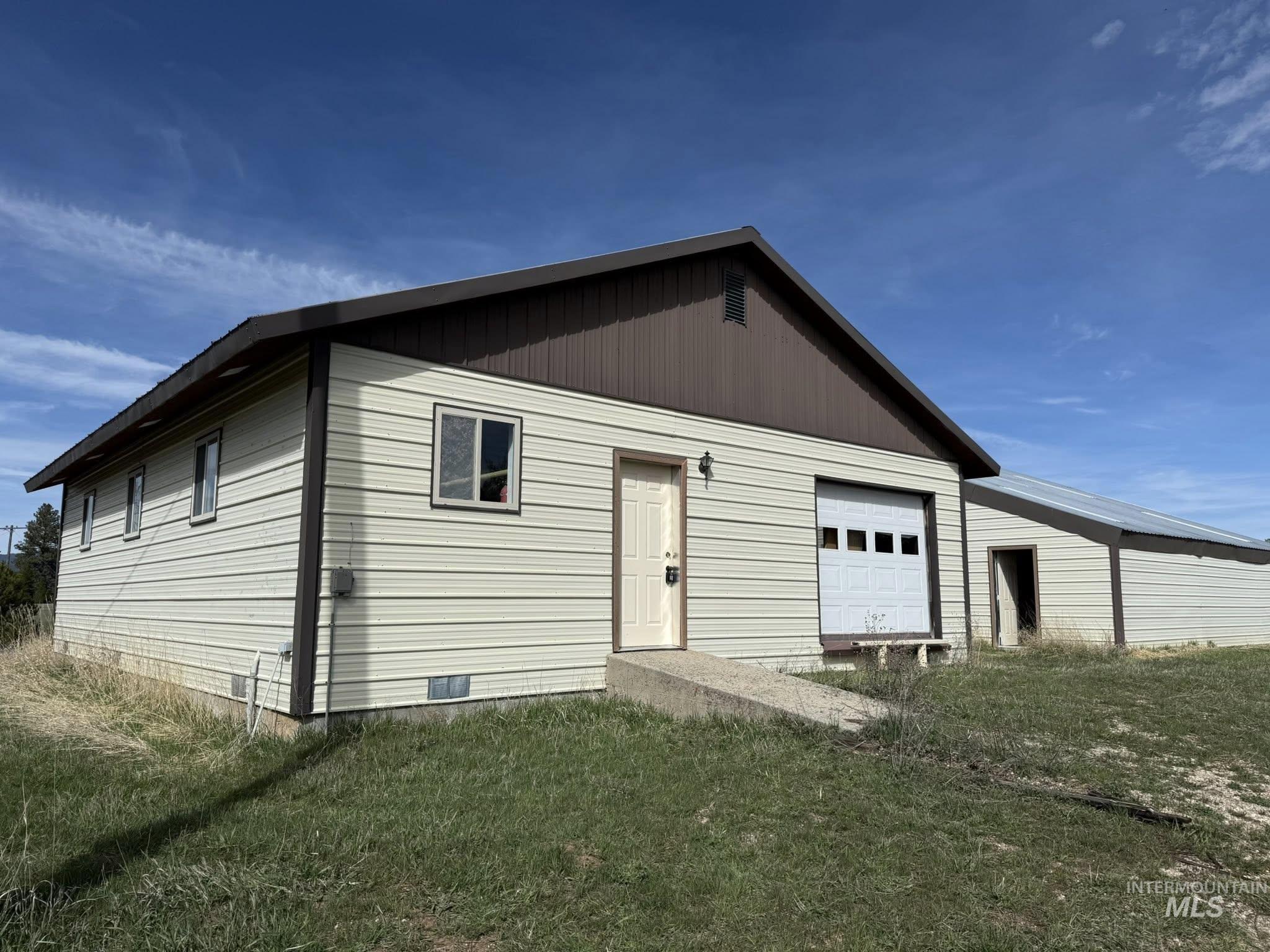 11100 Bens Road Cascade, ID 83611 - Photo 3 of 35 Exterior featuring light-colored horizontal siding and a dark brown gable roof