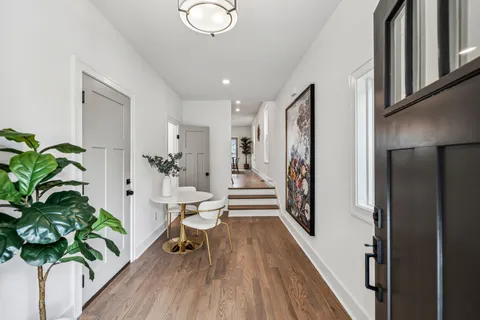 a very nice looking room with wooden floor and a potted plant