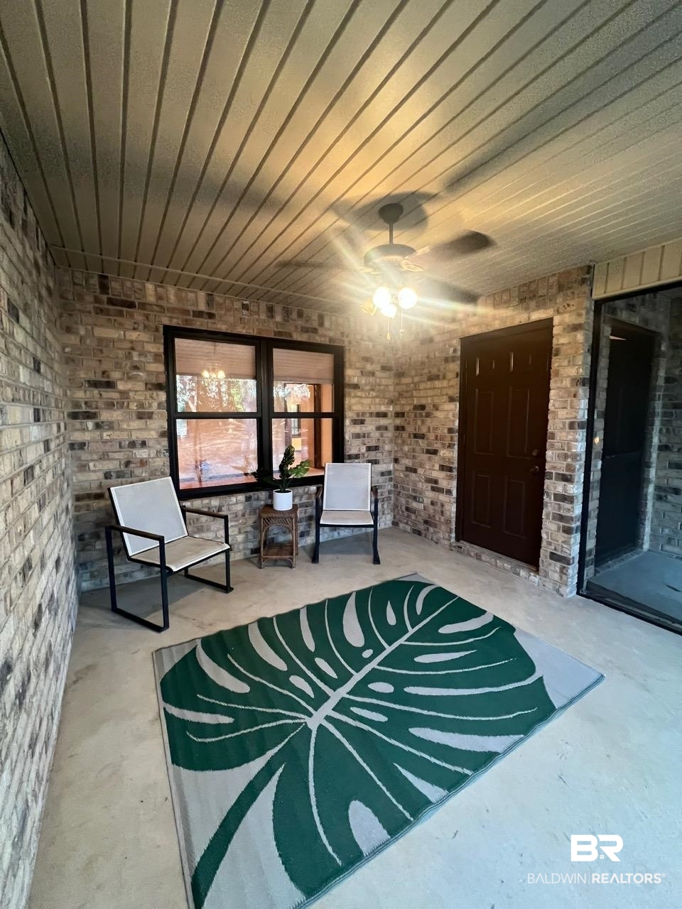2682 Pine Ridge Drive Lillian, AL 36549 - Photo 5 of 37 Interior space featuring concrete flooring, ceiling fan, and brick wall
