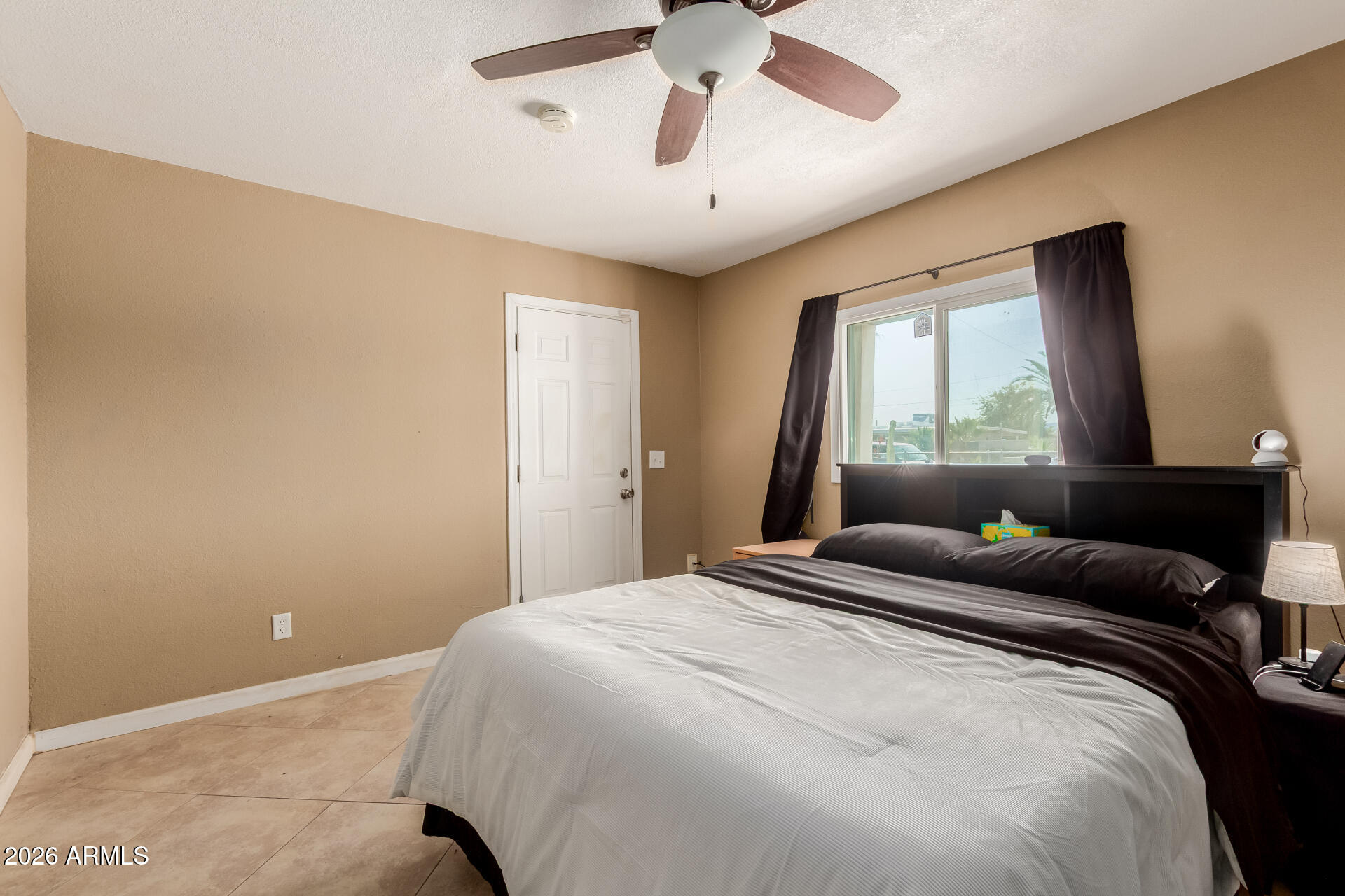1644 West Sonora Street Phoenix, AZ 85007 - Photo 13 of 29 a bedroom with a large bed and a chandelier