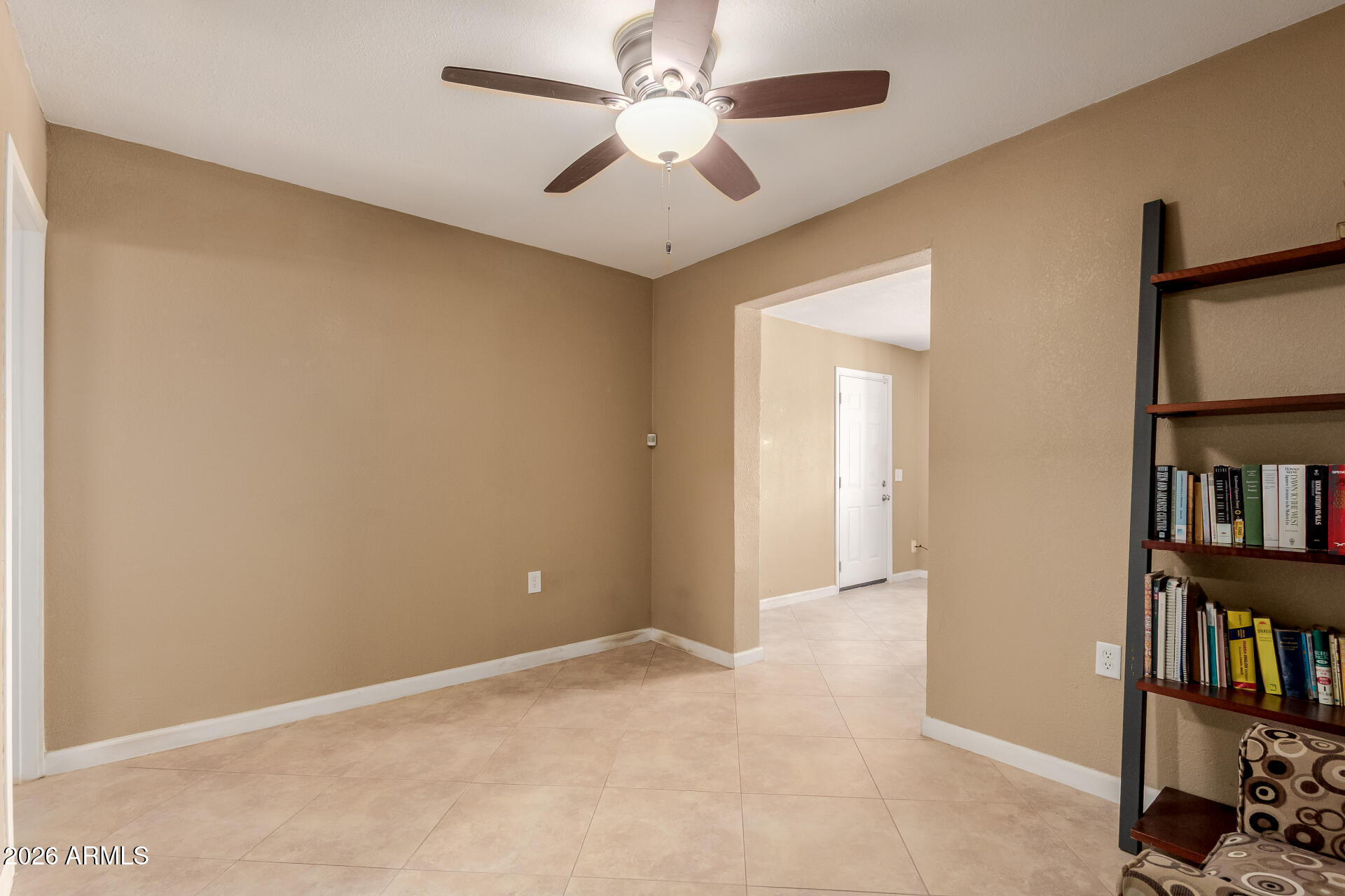 1644 West Sonora Street Phoenix, AZ 85007 - Photo 15 of 29 an empty room with bookshelf and a window